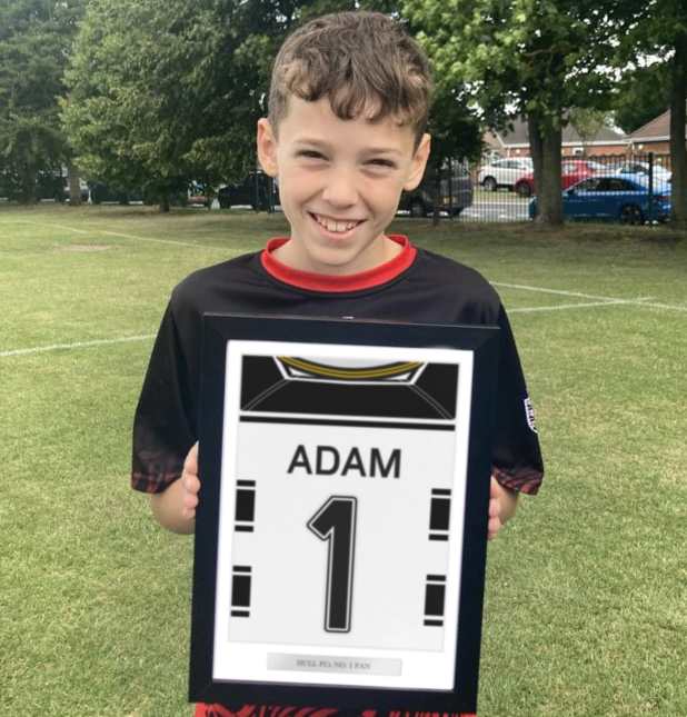 A personalised sports jersey back print hung on a wall in a tastefully decorated room, proudly featuring the team colours and custom name and number. Ideal for enhancing the ambiance in a child's bedroom, man cave, or sports bar