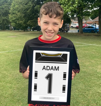 A personalised sports jersey back print hung on a wall in a tastefully decorated room, proudly featuring the team colours and custom name and number. Ideal for enhancing the ambiance in a child's bedroom, man cave, or sports bar